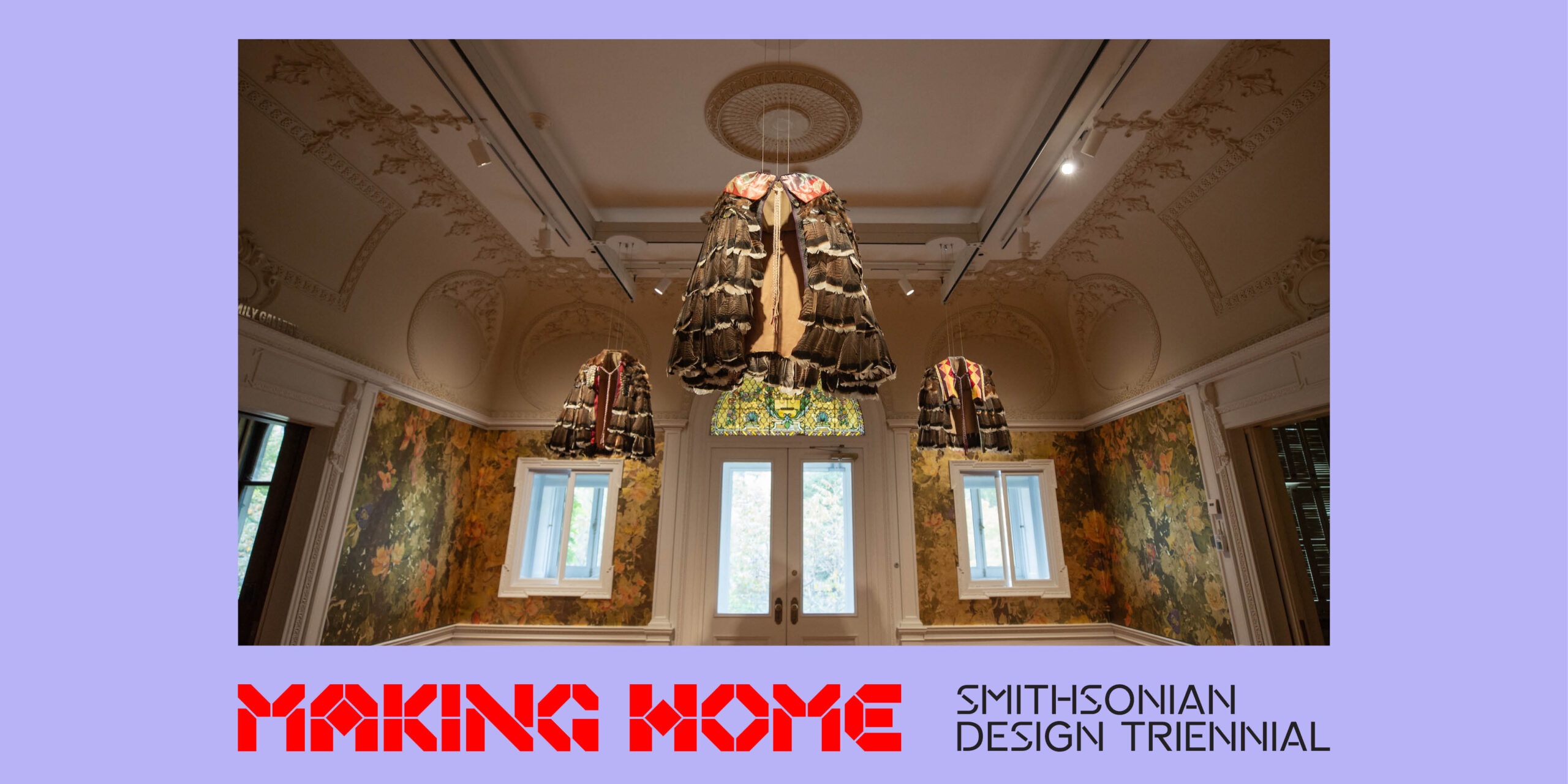 3 capes are suspended from the ceiling of a large, brightly lit room with windows on the back wall. The room has high ceilings, ornate crown molding, and the walls are decorated with floral wallpaper. The image is bordered in light purple. Text at the bottom reads: Making Home Smithsonian Design Triennial.