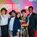 Group of 5 people in festive attire in front of National Design Awards background.