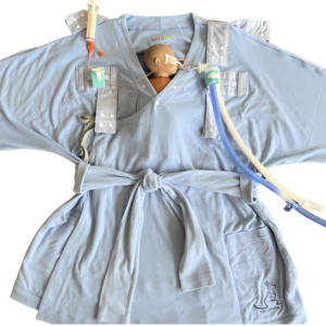 A pale blue robe labeled [Kangarobe] with a waist tie and a snap button neckline and series of Velcro straps to accommodate infant nursing, skin-to-skin contact, and medical device tubing.