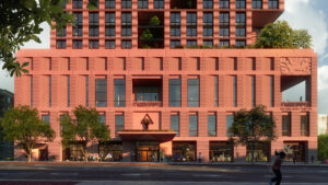 A terracotta-colored multi-storied building facade decorated with many rectangular windows and labeled [National Black Theater].